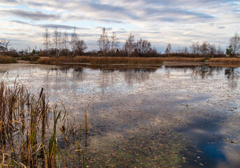 Clouds in the sky with reflection in the lake at sunset.