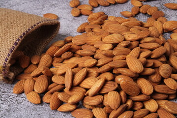 Almonds in bag isolated on grey background