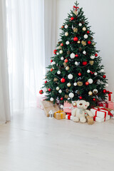 Decorated room with beautiful Christmas tree and gifts