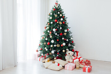 Decorated room with beautiful Christmas tree and gifts