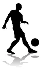 A soccer or football player in silhouette