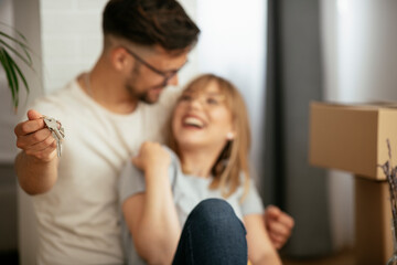 Close up of husband and wife holding the key to their new apartment..