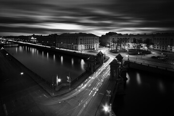 Fototapeta premium Long exposure cityscape of Fontanka river and Lononosov bridge, Saint-Petersburg, Russia, black and white