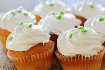 Cupcake decorated by cream meringue and sweet Christmas tree, dessert for party, birthday, new year eve, festive