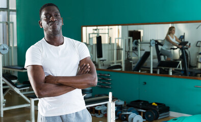 Fototapeta na wymiar Portrait of adult african man in sportswear welcoming to sport club