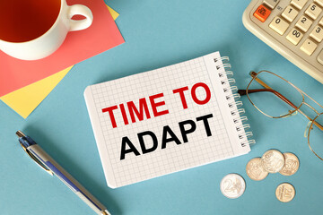 Business concept. Notebook with text TIME TO ADAPT
