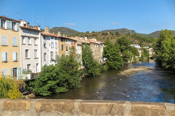 Fototapeta na wymiar Bridge over the river Aude with several houses on the bank, commune of Quillan, administrative region of Occitania, department of Aude, France