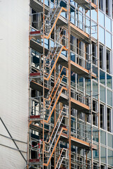 Scaffolding on a modern glass facade of a house