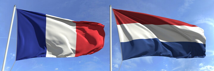 Waving flags of France and Netherlands on flagpoles, 3d rendering