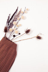 Fashion Flat lay warm sweater. Minimal fall winter  brunch decor. Stylish autumn, winter clothes shopping, sale concept, Beige brown colours trends