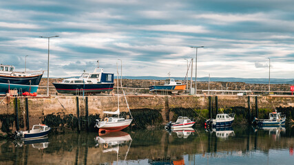 Boats Tied up at the Harbour Wall