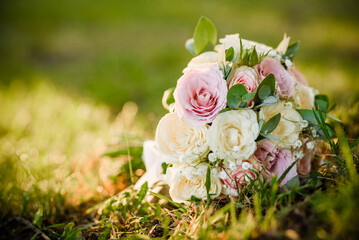 Beautiful wedding bouquet on the ground . Fresh roses bouquet