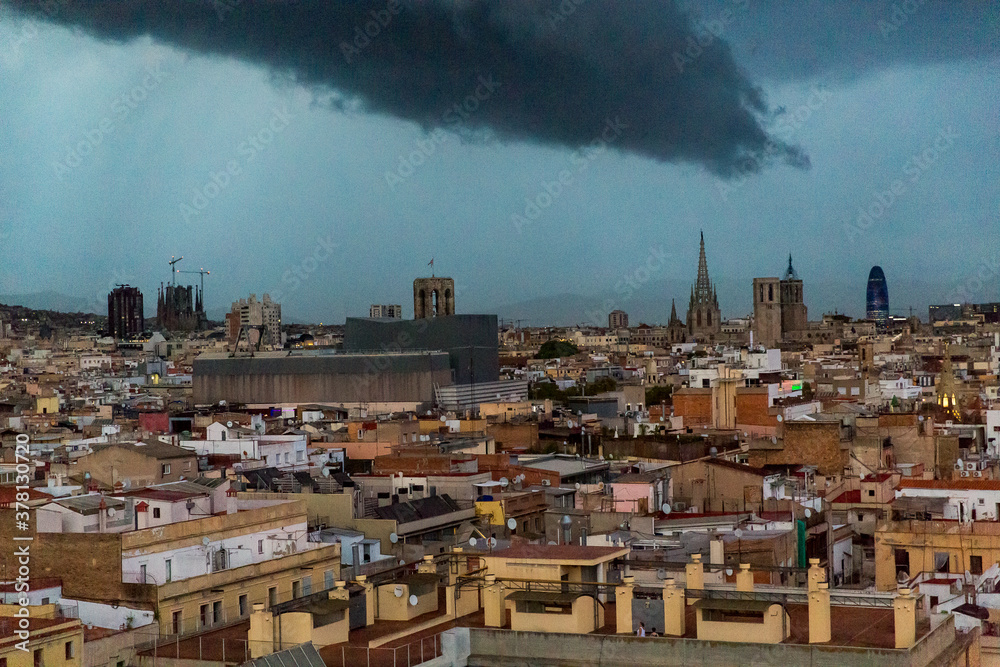 Wall mural Barcelona, Catalonia, Europe, Spain, September 22, 2019. Top panoramic view of the Barcelona landscape on sunset. Historical buildings in the background.