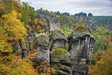 Picturesque autumn scenery with sandstone rocks and colorful trees, Saxon Switzerland, Germany