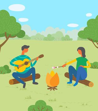 Man And Woman Friends Camping. They Are Sitting Around Camp Fire And Playing Guitar, Toast Marshmallows. Tourist Group On A Forest Walk Or Holiday Camp Play Music, Cook Food At The Stake On A Weekend