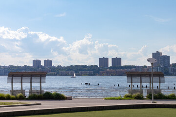 Fototapeta premium Beautiful Benches at Riverside Park South along the Hudson River in Lincoln Square New York during Summer