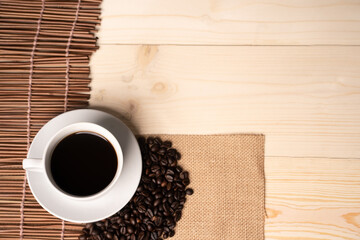 warm cup of coffee on brown background