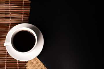 warm cup of coffee on brown background