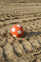 Soccer ball on dirty earth outdoor