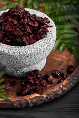 Dried cherry in a bowl over gray background. Top view.