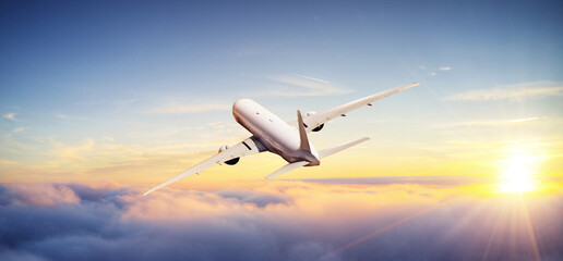 Naklejka na ściany i meble Huge commercial airplane flying above clouds.