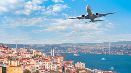 Fototapeta premium A passenger airplane is flying over istanbul city with blue Bosphorus sea and bridge