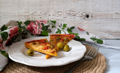 Vegetarian homemade pizza with mozzarella and olives on the white plate. Whitewood background.  Italian cuisine 