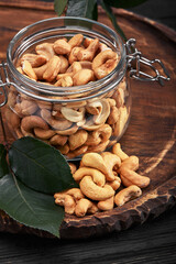 Bowl with cashew nuts on wooden table. Delicacies