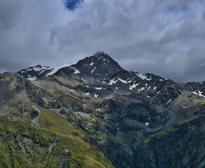 Snowy Avalanche Peak against a background of cloudy and stormy sky, Arthur's pass, South Island, New Zealand
