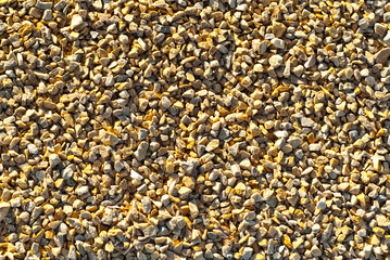 Drainage systems from small pebbles. Garden drainage for plants and trees. Yellow stones for roads and flower beds.