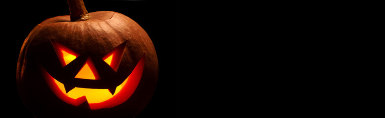 Halloween pumpkin with scary face. Jack-o-lantern in the dark