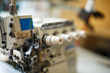 Fototapeta na wymiar closeup details on sewing machine overlock. Workplace seamstress.Tailoring industry