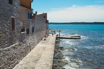 Fototapeta na wymiar Clear blue water of Adriatic sea in the resort Novigrad (Cittanova), Croatia