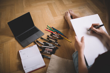 Crop woman using black felt pen for writing