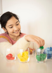 Girl sorting bottle caps for recycling