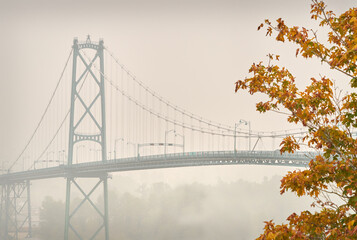 Lions Gate Bridge Fog. The Lions Gate Bridge over the First Narrows of Burrard Inlet on a foggy day. North Vancouver in the background.

