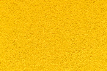 Rough patterned yellow cement wall texture and seamless background