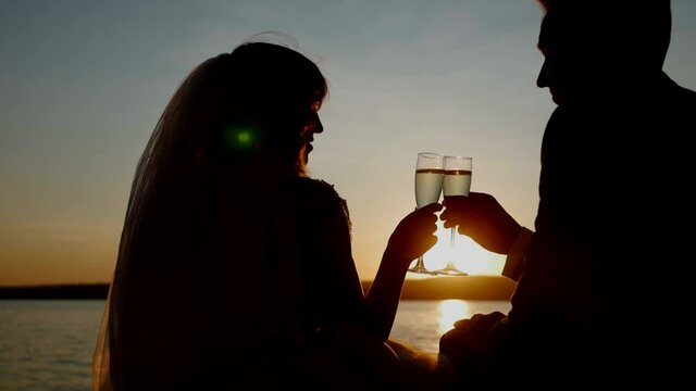 silhouette, glasses, brides, sunset, couple, champagne, alcohol, embracing, love, beach, man, woman, dress, suit, sun, sea, romantic, sky, romance, water, ocean, happy, nature, two, young, family, bea