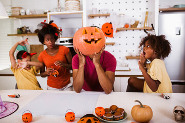 Happy family preparing for Halloween, having fun.