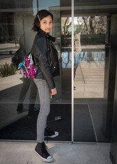 Teenager entering her building, returning home