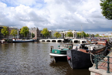 View on the famous Skinny Bridge (Magere Brug ), a bascule bridge made of white-painted wood, over the river Amstel in the center of Amsterdam