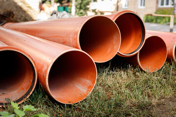 Plastic water pipes lie on the ground