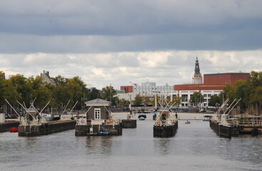 View over the river Amstel in the center of Amsterdam on the Amstel locks and the tower of the Southern church (Zuiderkerk) in the background