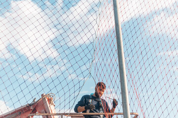 man working at heights with lifting platform.
