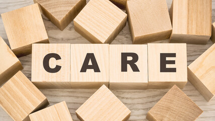 word care with black letters on toy wooden blocks on table