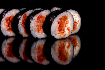 Fresh delicious beautiful sushi rolls on a dark background