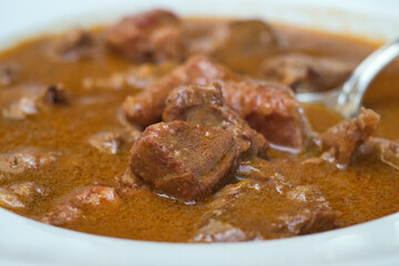 Traditional Croatian rustic meat dish - venison gulash with rich berry and mushroom sauce 