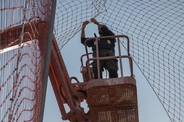 man working at heights with lifting platform.