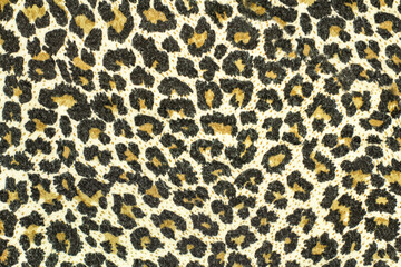 Texture of speckled leopard fabric. Wildlife animal background