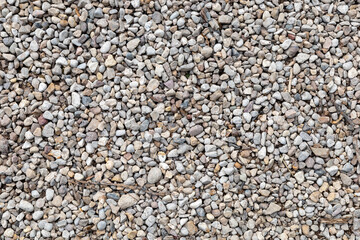Top view of textured yellow and white pebble stones ground